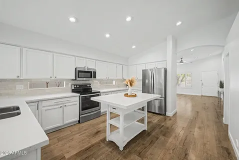 a kitchen with a sink stove and microwave