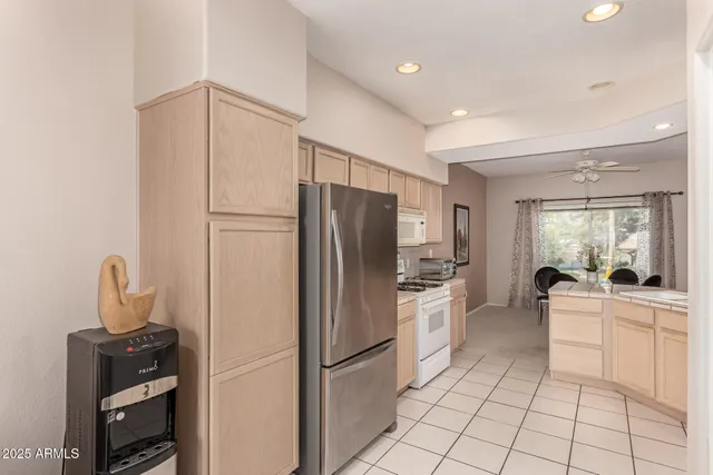 a kitchen with stainless steel appliances a refrigerator sink and cabinets