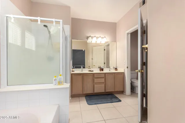 a bathroom with a bathtub a sink and a mirror