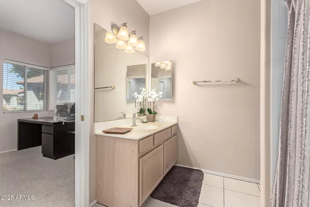 a bathroom with a granite countertop sink a toilet and a mirror