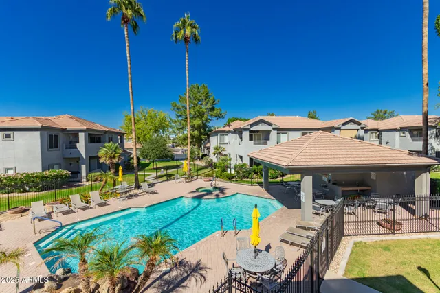 a view of a patio with table and chairs potted plants