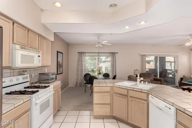 a kitchen with sink stove and cabinets