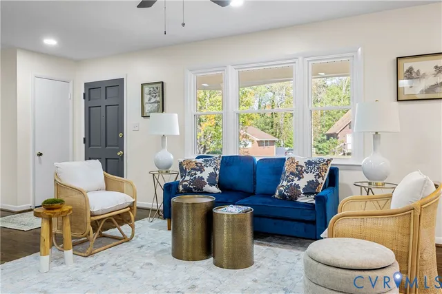 a living room with furniture and a large window