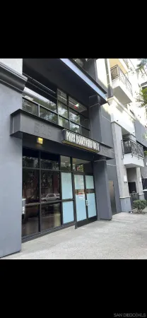 a view of a patio with couches table and chairs potted plants and palm trees