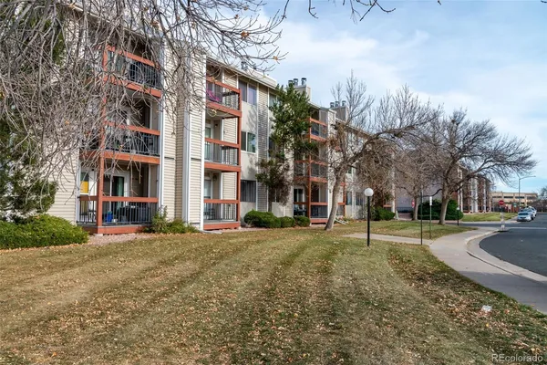 a city street lined with buildings and trees
