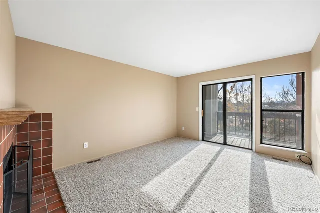 a view of a livingroom with an empty space and a fireplace