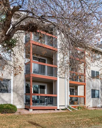 a tennis court with view of buildings in the background