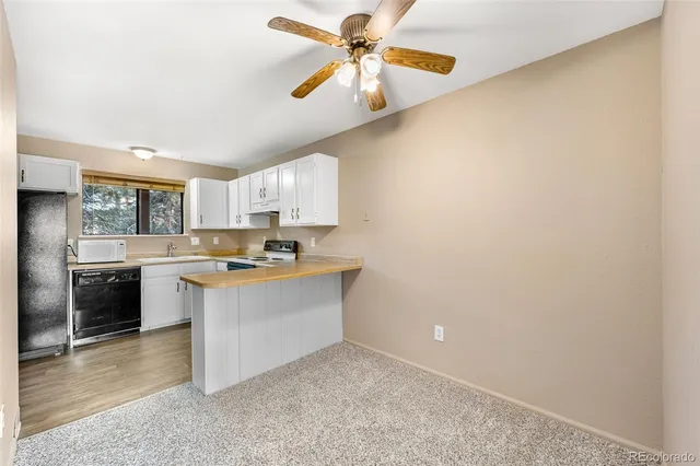 a kitchen with stainless steel appliances granite countertop a refrigerator a stove and a sink