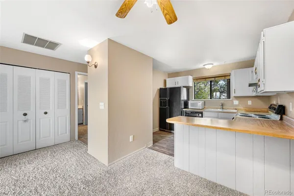 a kitchen with stainless steel appliances granite countertop a refrigerator a stove and a sink