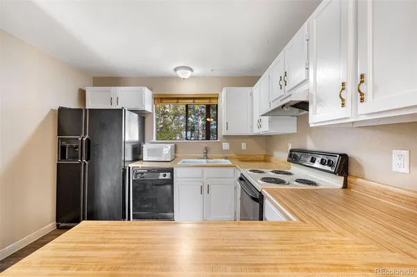 a kitchen with a sink stove and refrigerator