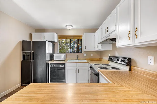 a kitchen with a sink stove and refrigerator
