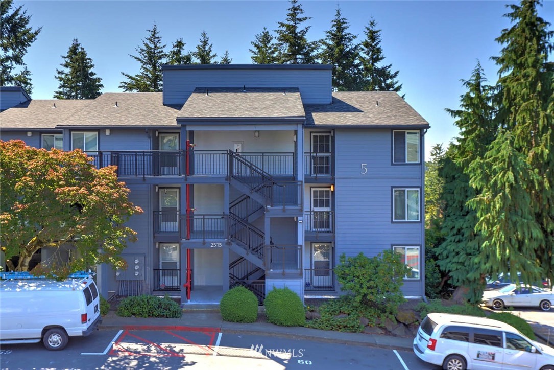 2515 Northeast 4th Street, Unit 531 Renton, WA 98056 - Photo 3 of 28 a front view of a house with a garden