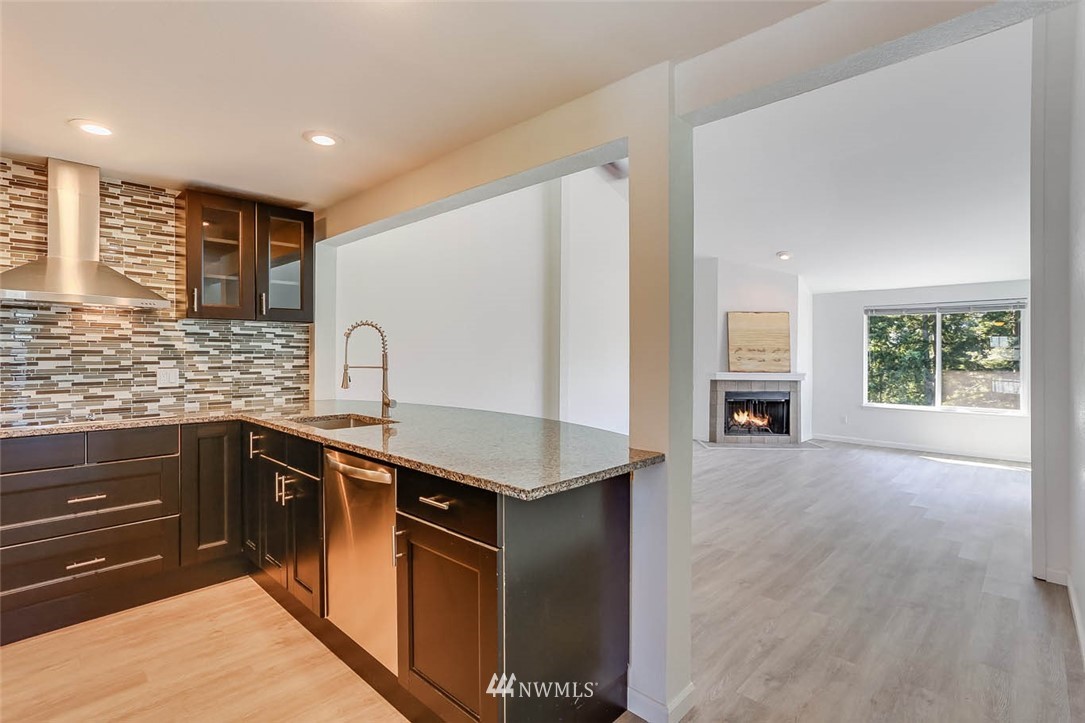 2515 Northeast 4th Street, Unit 531 Renton, WA 98056 - Photo 6 of 28 a kitchen with stainless steel appliances granite countertop a sink stove and refrigerator