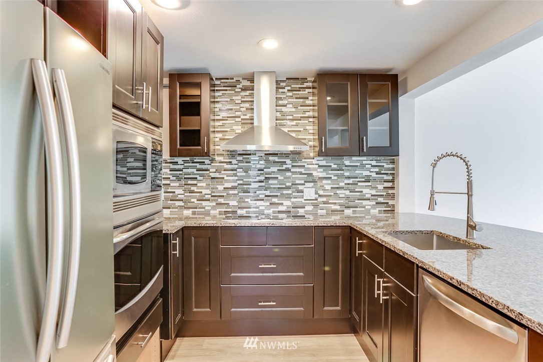 2515 Northeast 4th Street, Unit 531 Renton, WA 98056 - Photo 7 of 28 a kitchen with stainless steel appliances granite countertop a sink and cabinets