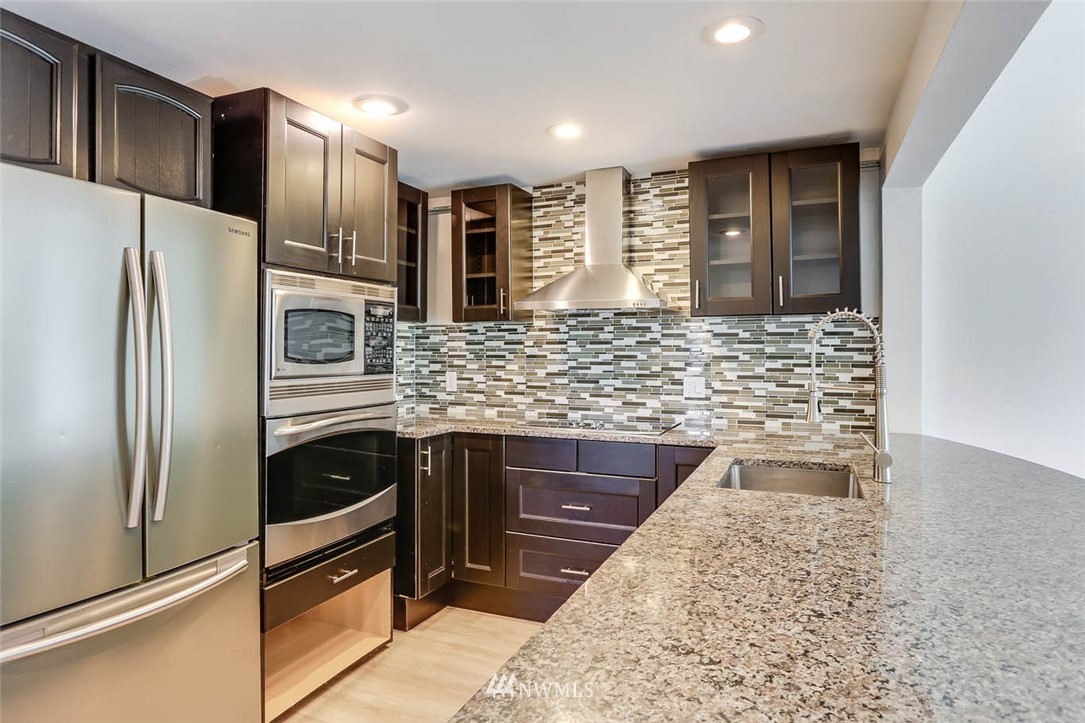 2515 Northeast 4th Street, Unit 531 Renton, WA 98056 - Photo 8 of 28 a kitchen with stainless steel appliances granite countertop a refrigerator a stove and a sink