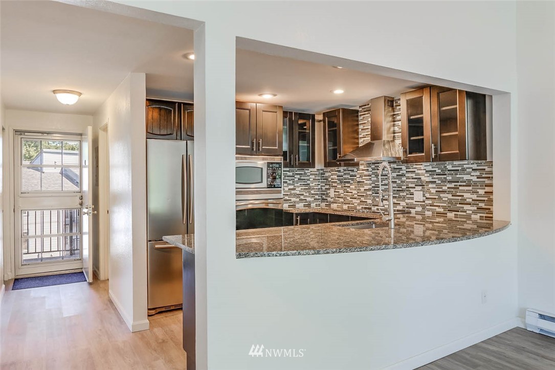 2515 Northeast 4th Street, Unit 531 Renton, WA 98056 - Photo 9 of 28 a living room with stainless steel appliances kitchen island granite countertop a refrigerator and a sink