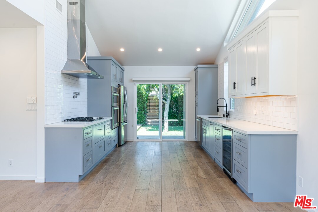 4518 Alla Road Los Angeles, CA 90066 - Photo 4 of 23 a kitchen with stainless steel appliances granite countertop a stove a refrigerator a sink dishwasher and wooden cabinets with wooden floor