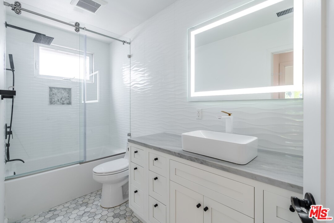 4518 Alla Road Los Angeles, CA 90066 - Photo 10 of 23 a bathroom with a granite countertop toilet sink and mirror