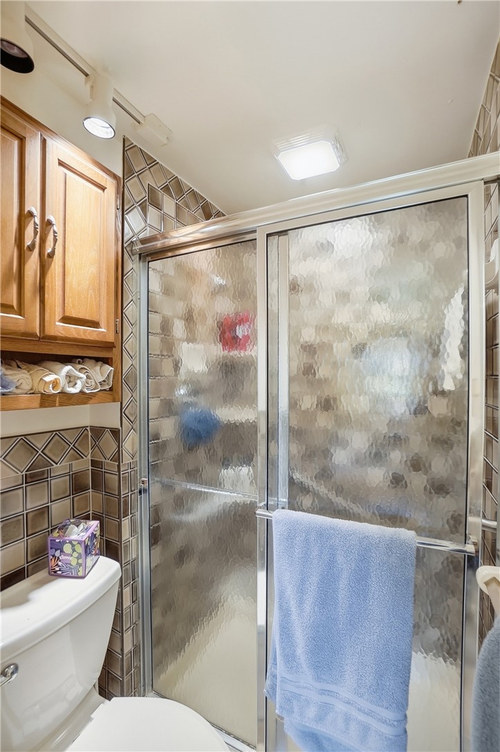 6225 Possum Run Road Bellbrook, OH 45305 - Photo 20 of 33 This bathroom features a sleek glass shower enclosure with stylish tiled walls.