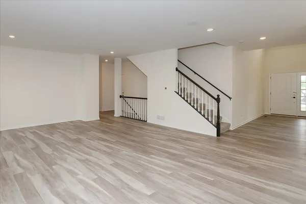 a view of empty room with wooden floor