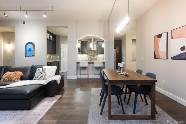 a living room with furniture and view of kitchen