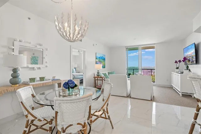 a living room with furniture a flat screen tv and a large window