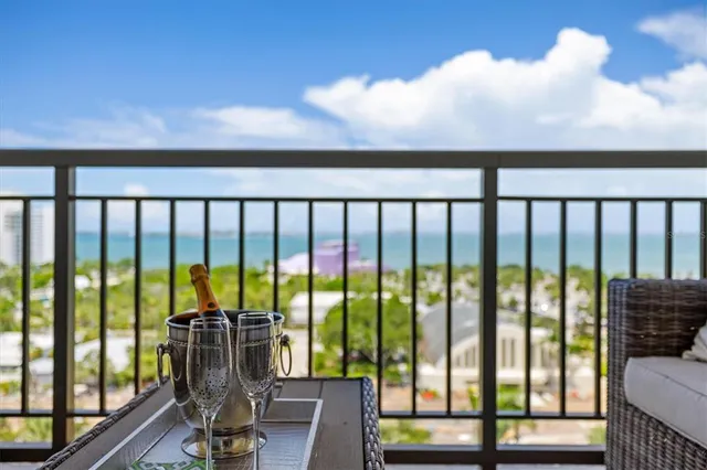 a kitchen with stainless steel appliances granite countertop a sink a microwave refrigerator and chairs