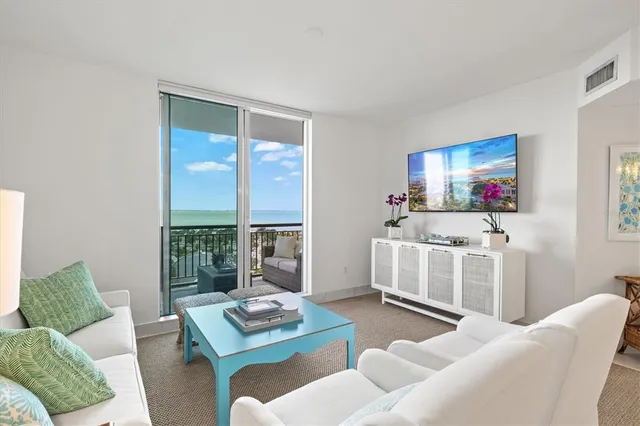 a bedroom with a bed and a flat tv screen on dresser