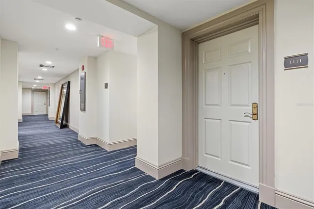 a front view of a building with garden and plants