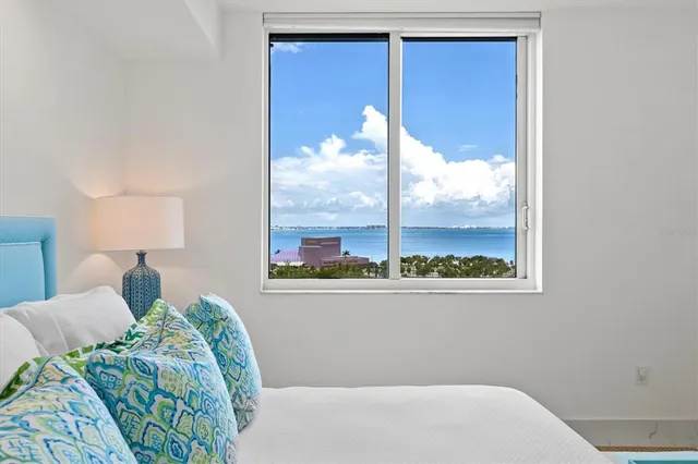a living room with furniture a chandelier and a dining table