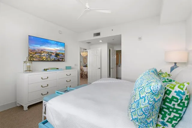 a kitchen with stainless steel appliances granite countertop a stove top oven a sink a dining table and chairs with wooden floor