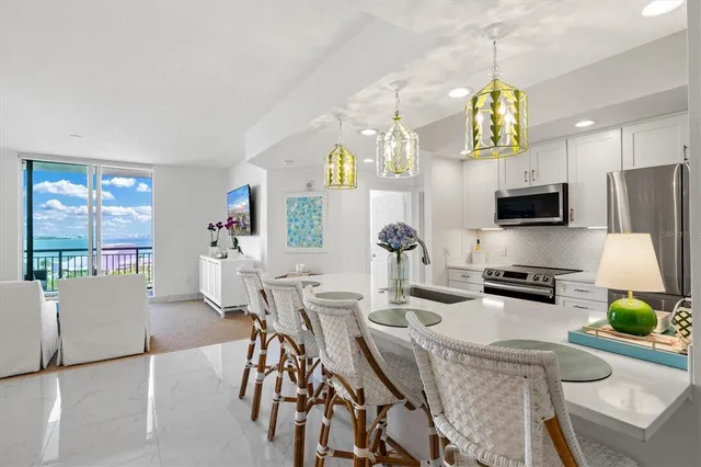 a view of a dining room with furniture and chandelier