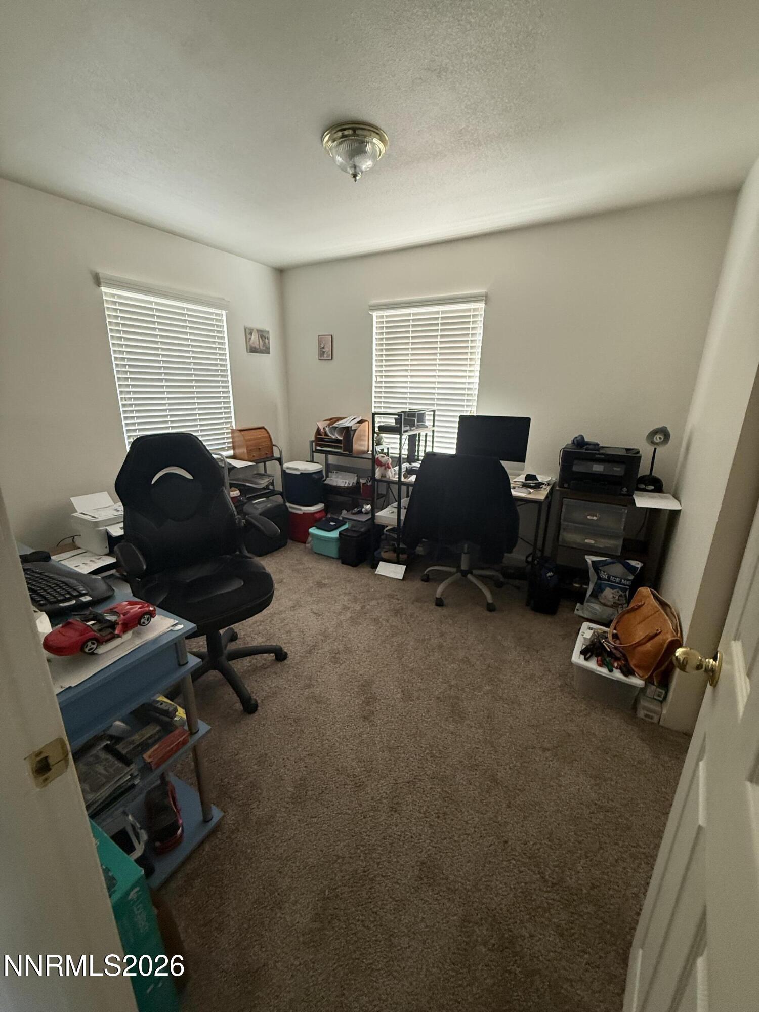 5424 Desert Hills Loop Fallon, NV 89406 - Photo 13 of 21 a living room with furniture a flat screen tv and gym equipment