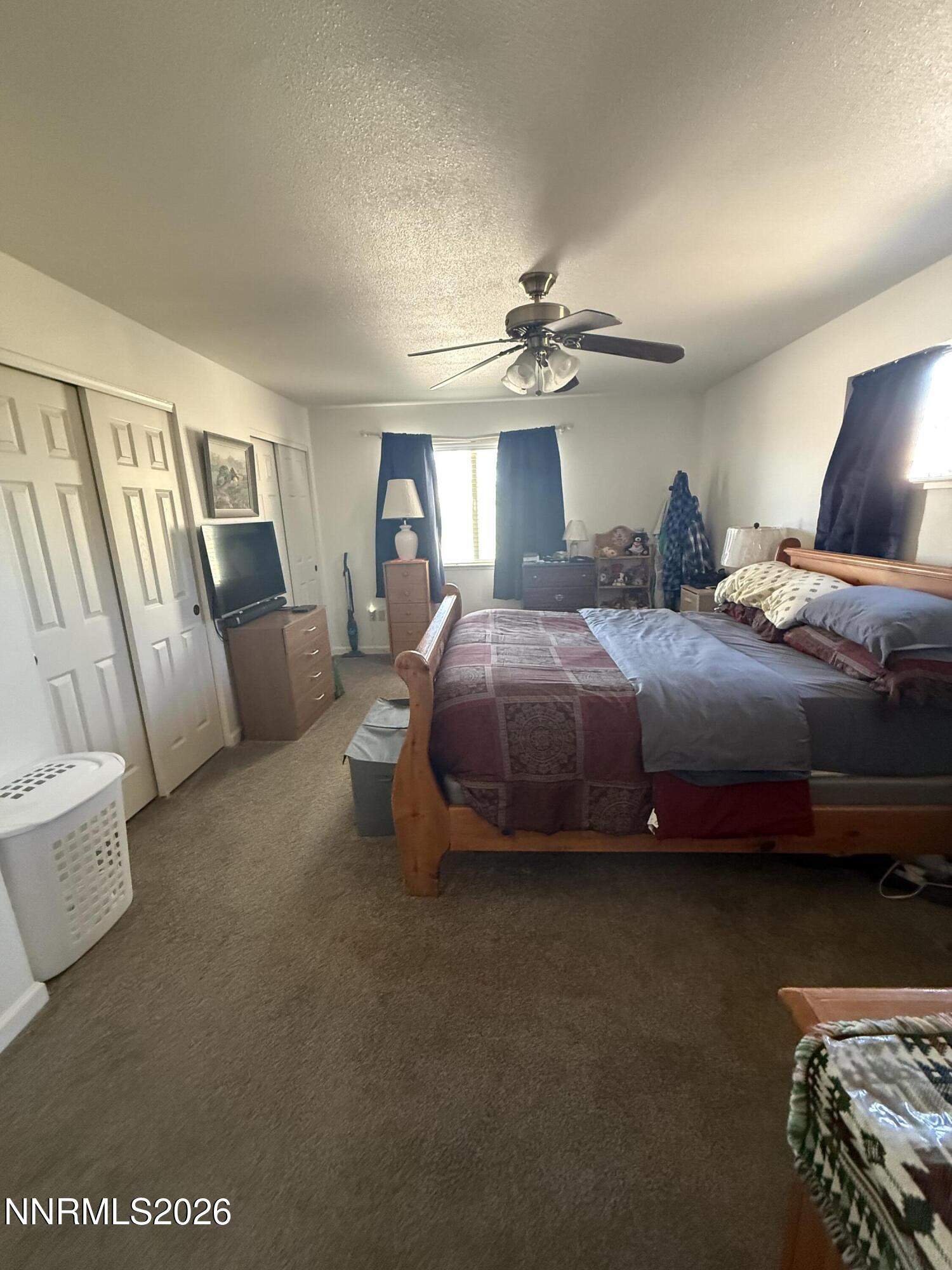 5424 Desert Hills Loop Fallon, NV 89406 - Photo 5 of 21 a bedroom with a bed and a chandelier