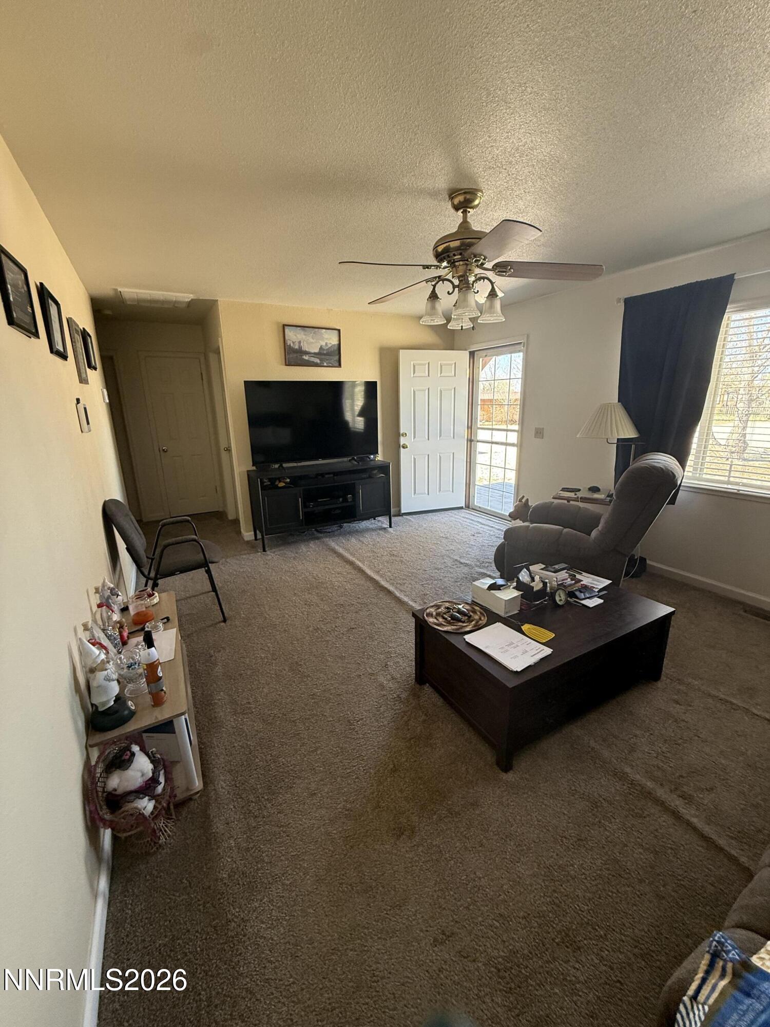 5424 Desert Hills Loop Fallon, NV 89406 - Photo 10 of 21 a living room with furniture and a chandelier