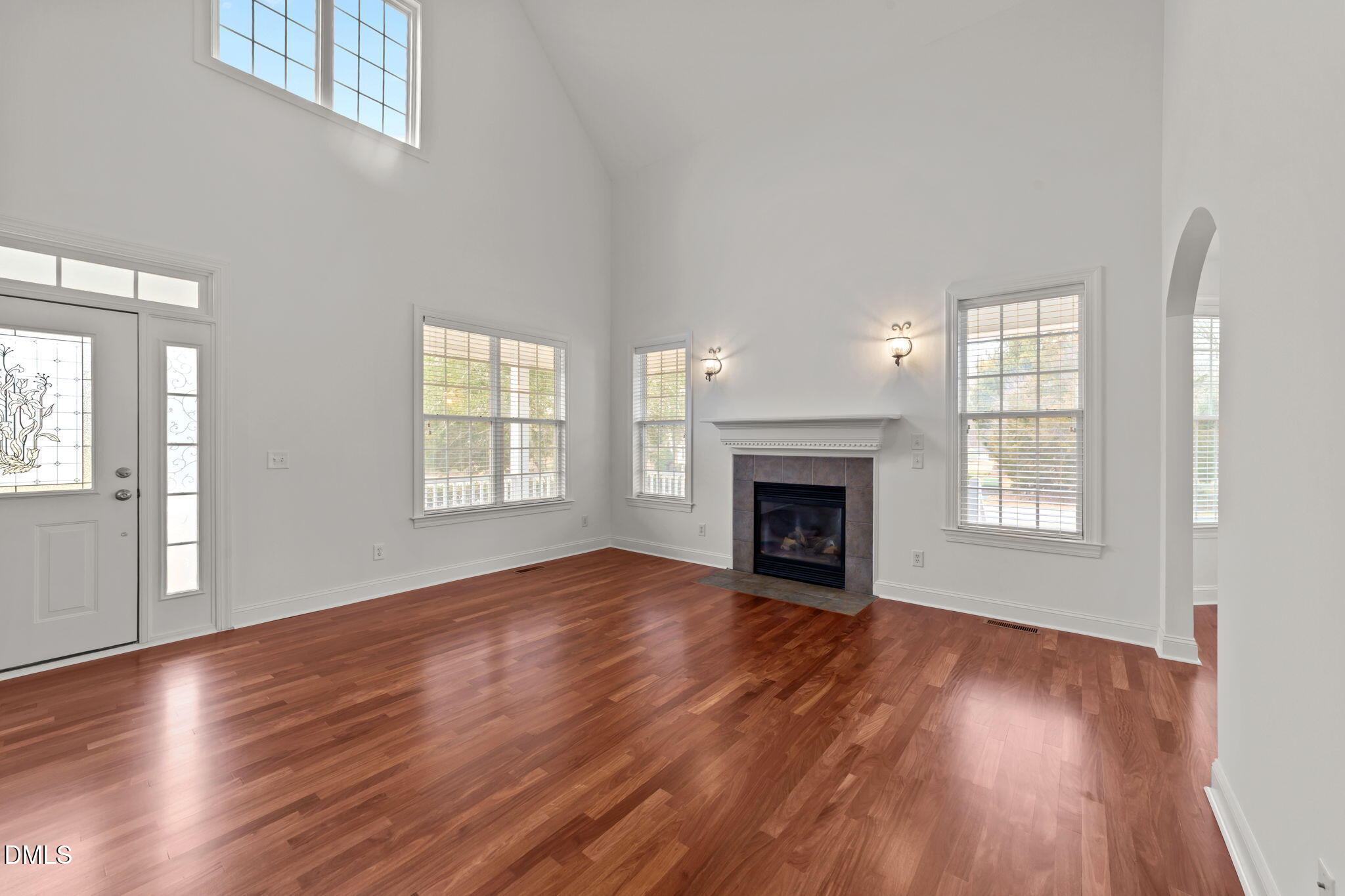 7101 Numa Circle Willow Spring, NC 27592 - Photo 3 of 44 a view of an empty room with wooden floor fireplace and a window