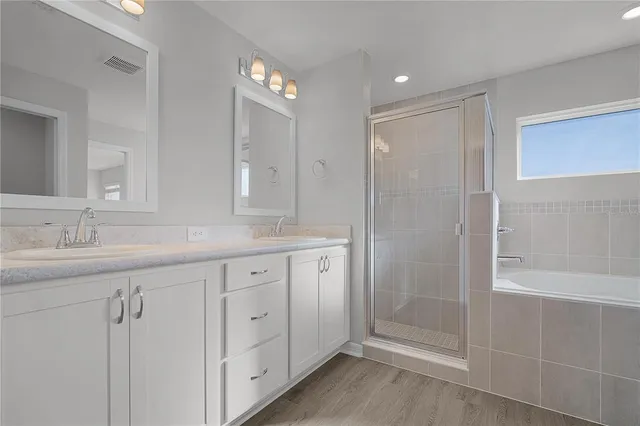 a bathroom with a granite countertop sink a toilet and a large mirror