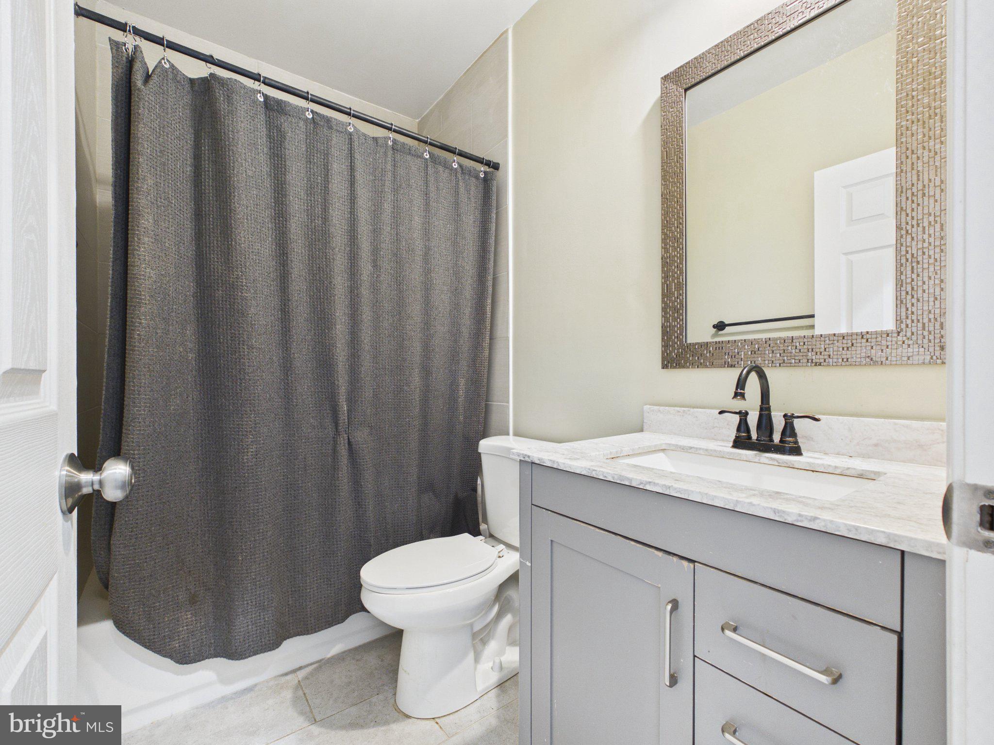 38565 Piggott Bottom Road Hamilton, VA 20158 - Photo 57 of 85 a bathroom with a granite countertop sink toilet and a mirror