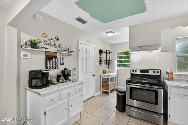 a kitchen with a stove and a cabinet
