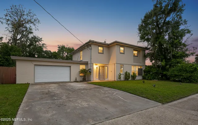 a front view of a house with a yard and garage