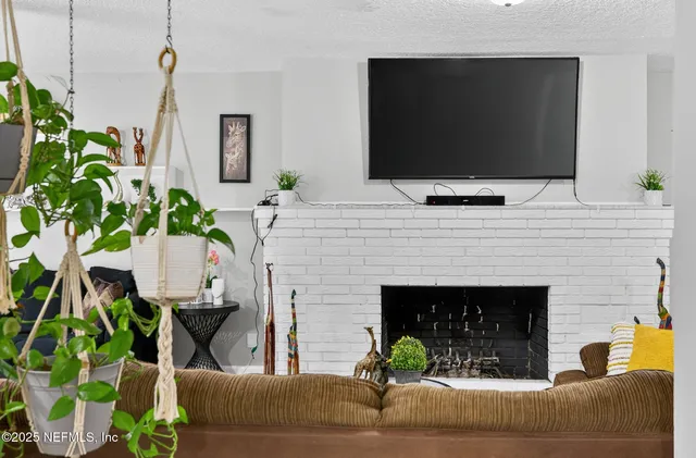 a living room with furniture and a fireplace