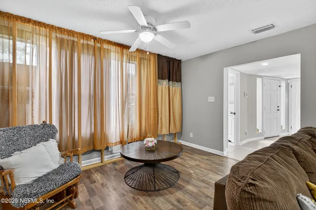 a living room with furniture fireplace and flat screen tv