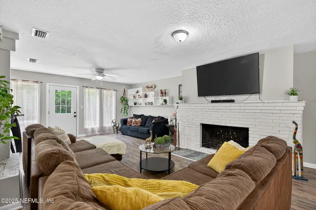 a view of a room with furniture and windows
