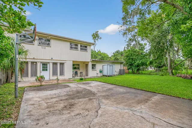 a view of a house with a yard and sitting area