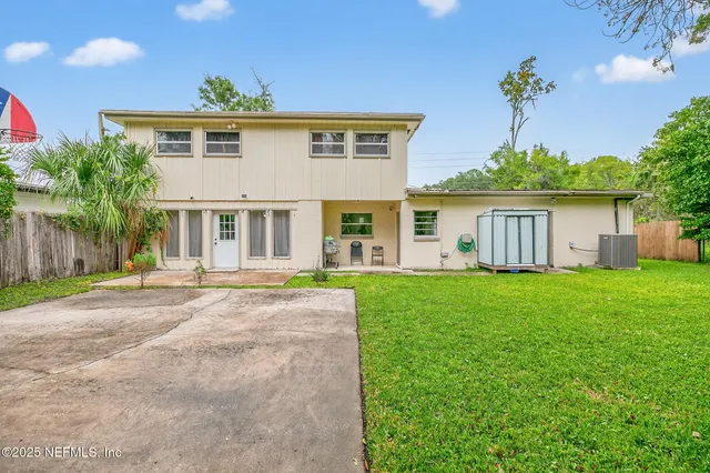 a view of a chair and table in the garden