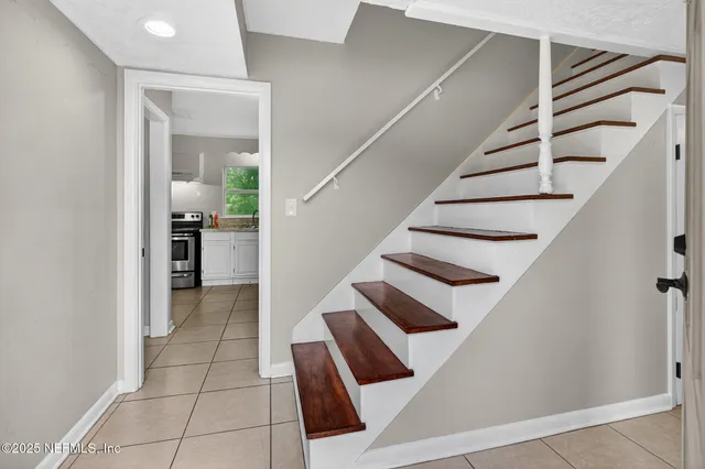 a view of staircase with white walls and railing