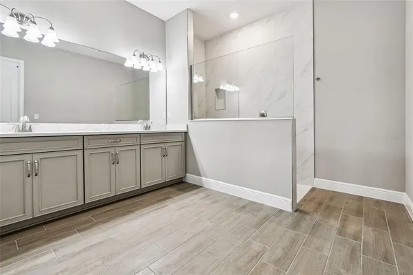 a view of a double sink and a mirror of lamp