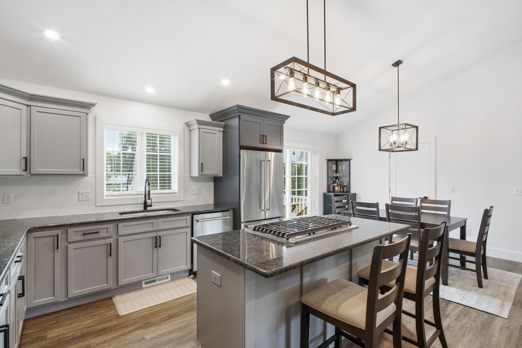 39 Jean Circle Chicopee, MA 01020 - Photo 11 of 33 a kitchen with a table and chairs in it