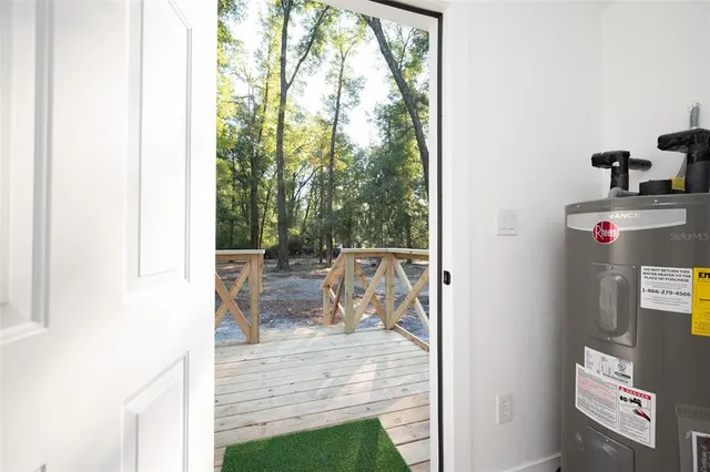 a view of a living room with a fireplace and a window