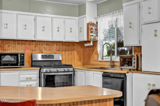 a kitchen with stainless steel appliances granite countertop a stove and a sink